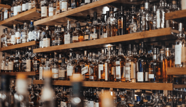 Wall of spirits at a local craft distillery – covered by Crafted Insurance