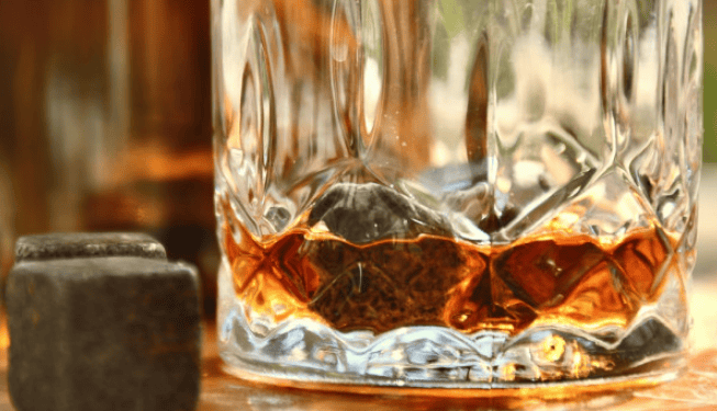 Close-up of a whisky glass with whiskey stones at a micro distillery – insured by Crafted Insurance