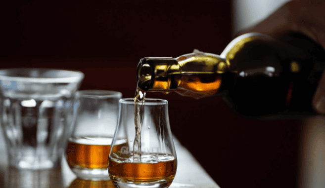 Whisky being poured into tasting glasses at a nano distillery – covered by Crafted Insurance